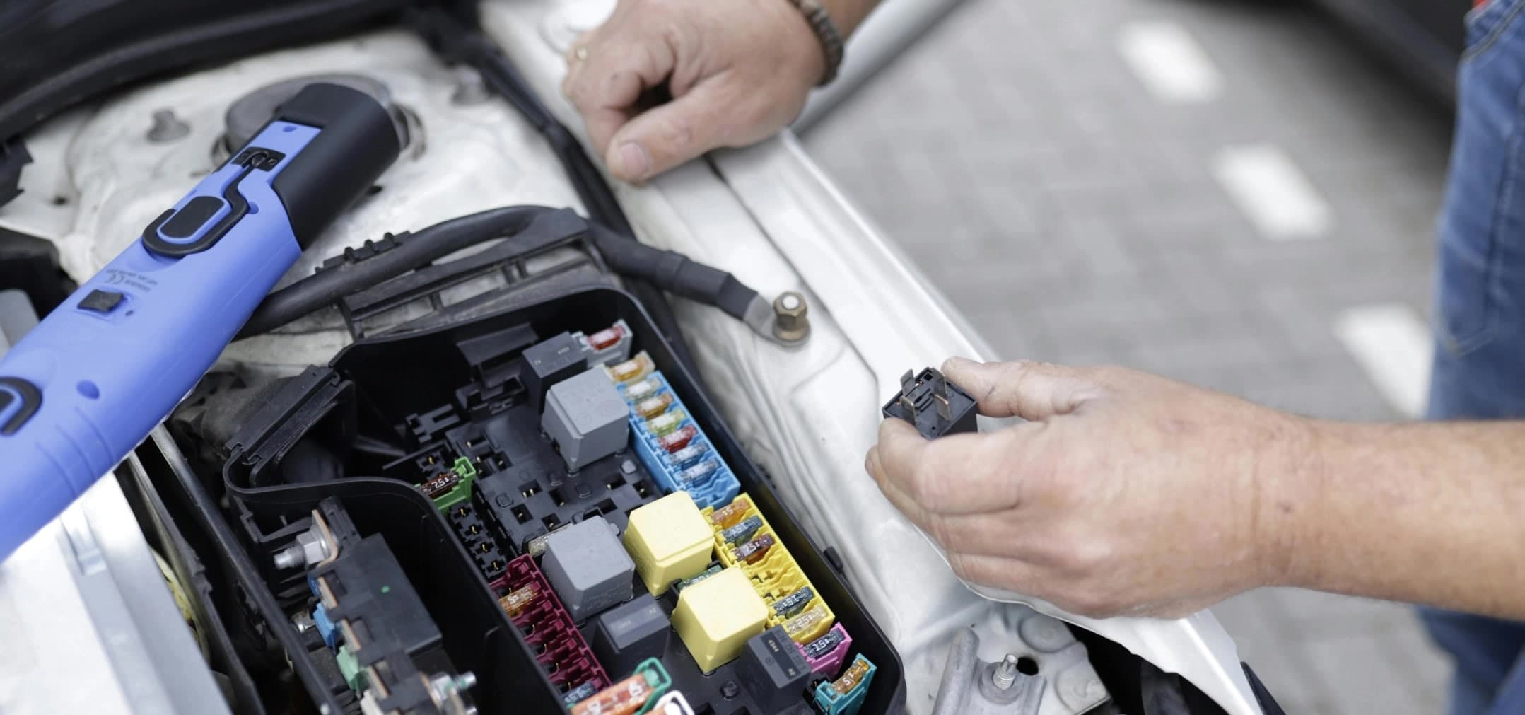 Automotive relays and wiring loom on a garage workbench
